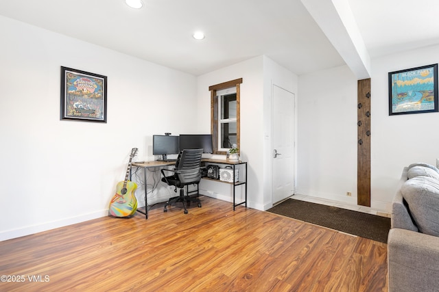 office featuring baseboards, wood finished floors, and recessed lighting