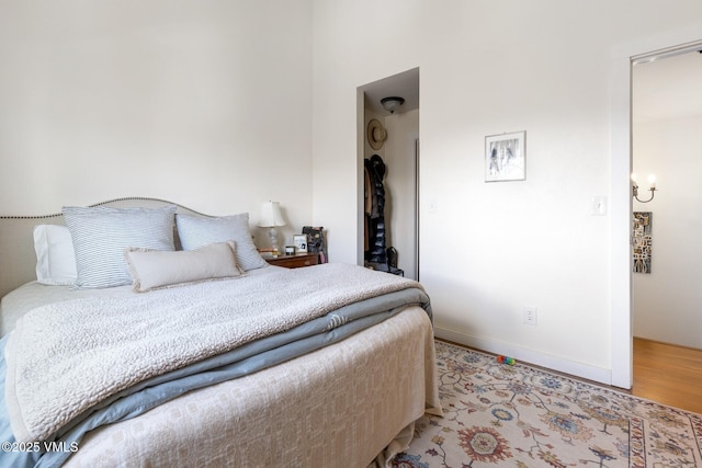 bedroom with light wood-style flooring and baseboards