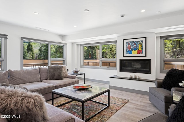 1650 Fallridge Rd Unit 120, Vail, CO 81657 - living area with wood finished floors, a glass covered fireplace, recessed lighting, and baseboards