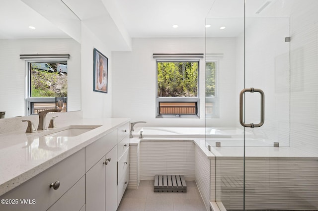 1650 Fallridge Rd Unit 120, Vail, CO 81657 - bathroom featuring vanity, a bath, a stall shower, tile patterned flooring, and recessed lighting