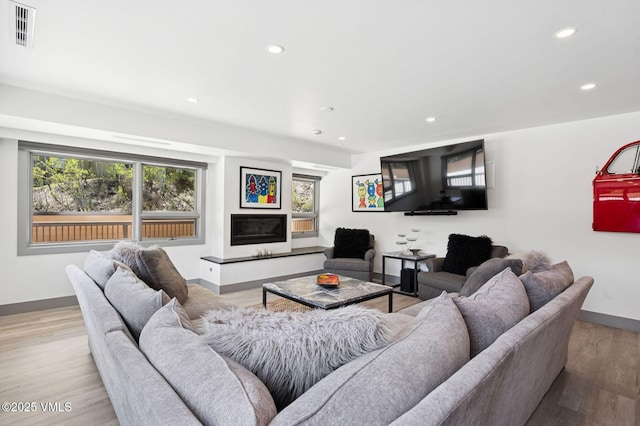 1650 Fallridge Rd Unit 120, Vail, CO 81657 - living area featuring baseboards, recessed lighting, light wood finished floors, and a glass covered fireplace
