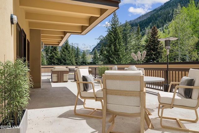 1650 Fallridge Rd Unit 120, Vail, CO 81657 - view of patio featuring a mountain view, outdoor dining space, and a forest view