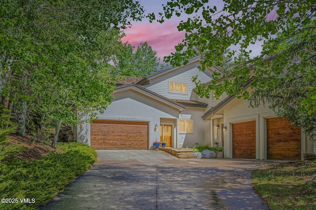 803 June Creek Rd, Edwards, CO 81632 - view of front of property with driveway, an attached garage, and stucco siding