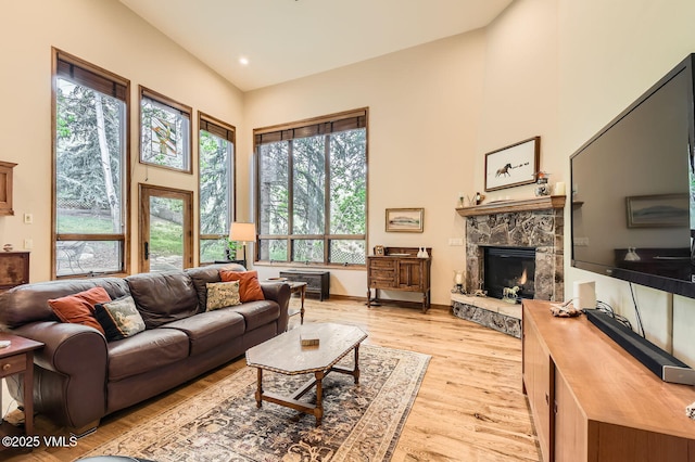 803 June Creek Rd, Edwards, CO 81632 - living area with a towering ceiling, a stone fireplace, and light wood-style flooring