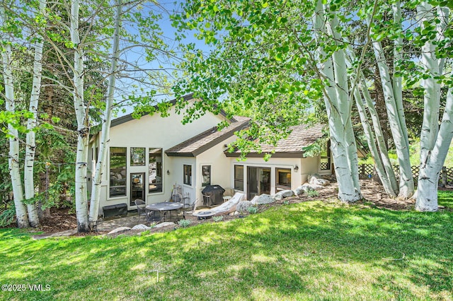 803 June Creek Rd, Edwards, CO 81632 - rear view of house with stucco siding, a lawn, and a patio