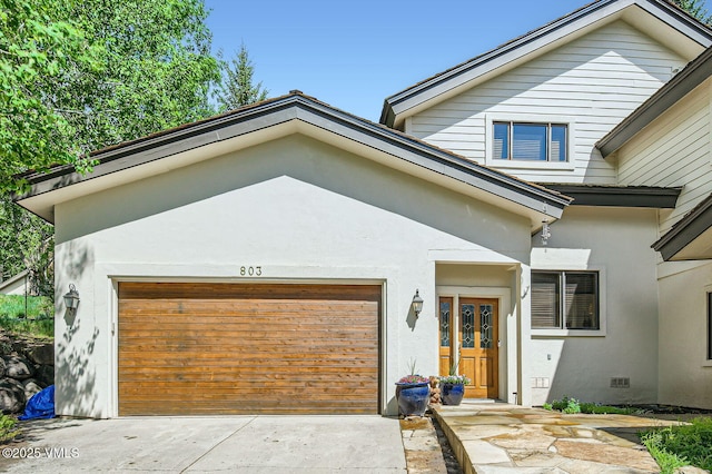 803 June Creek Rd, Edwards, CO 81632 - view of front of property featuring a garage, stucco siding, and driveway