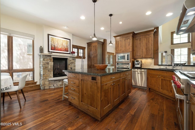 80 Mountain Retreat Ct, Edwards, CO 81632 - kitchen featuring stainless steel appliances, brown cabinets, dark wood finished floors, and recessed lighting