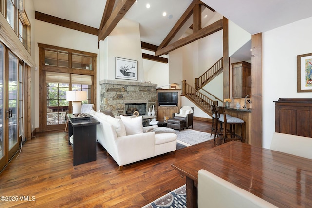 80 Mountain Retreat Ct, Edwards, CO 81632 - living room featuring high vaulted ceiling, stairway, a fireplace, beam ceiling, and wood finished floors