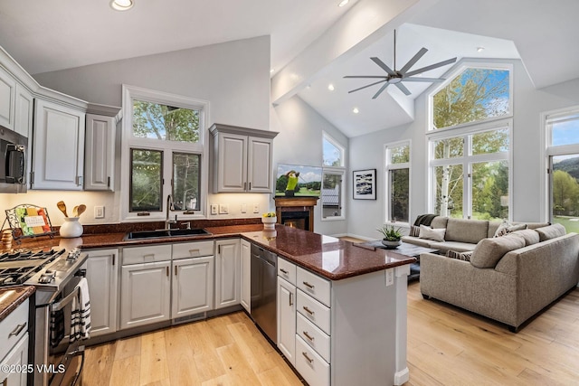 210 June Creek Rd Unit A, Edwards, CO 81632 - kitchen featuring a sink, dishwasher, a peninsula, stainless steel gas stove, and high vaulted ceiling