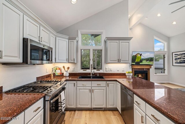 210 June Creek Rd Unit A, Edwards, CO 81632 - kitchen with appliances with stainless steel finishes, a sink, light wood-style floors, healthy amount of natural light, and high vaulted ceiling