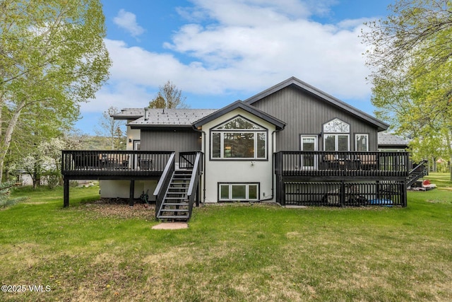 210 June Creek Rd Unit A, Edwards, CO 81632 - rear view of house with stairs, a wooden deck, and a lawn