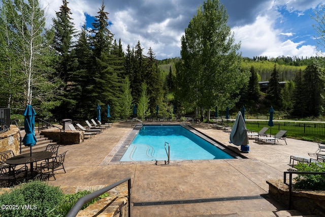 660 Lionshead Pl Unit 9, Vail, CO 81657 - community pool featuring a patio and a forest view