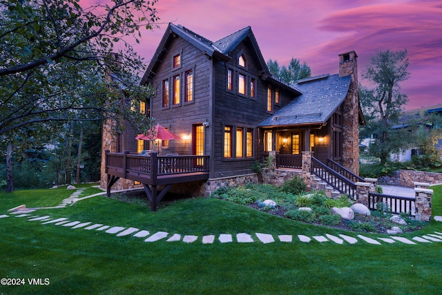 view of front facade featuring a yard and a deck