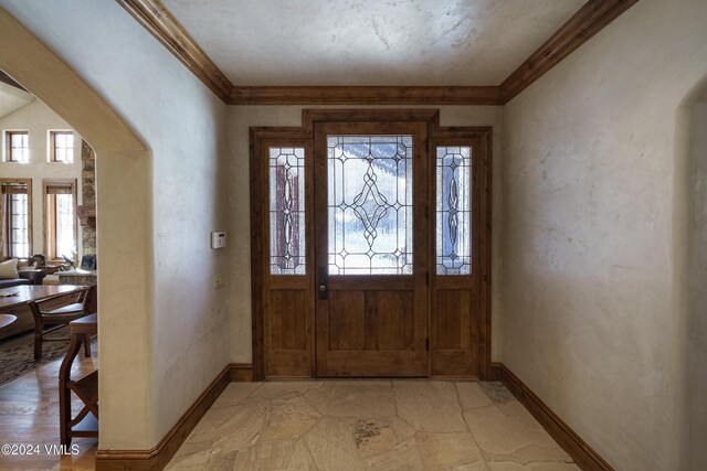 entrance foyer featuring ornamental molding