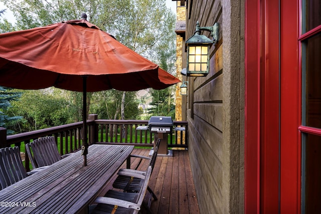 wooden deck featuring a grill