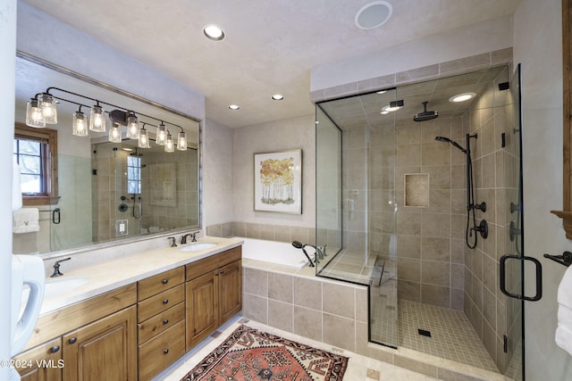 bathroom with tile patterned floors, vanity, and separate shower and tub