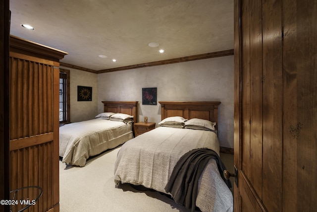 bedroom featuring ornamental molding and carpet flooring