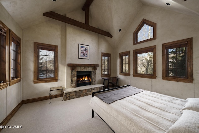 carpeted bedroom with high vaulted ceiling and a fireplace