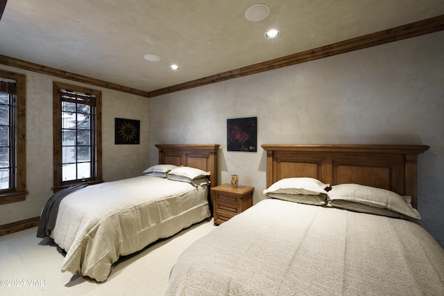 bedroom featuring crown molding and light carpet