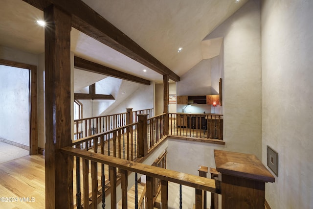 interior space with high vaulted ceiling, beam ceiling, and light hardwood / wood-style floors