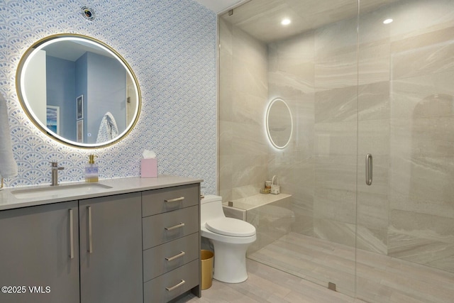 1658 E Haystacker Dr, Eagle, CO 81631 - full bath featuring toilet, a shower stall, vanity, wallpapered walls, and recessed lighting