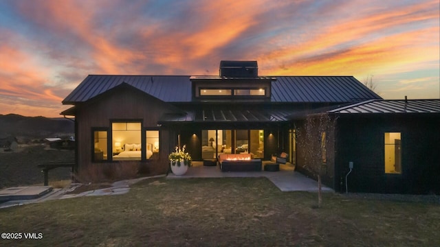 1658 E Haystacker Dr, Eagle, CO 81631 - back of house featuring a standing seam roof, an outdoor hangout area, metal roof, and a patio