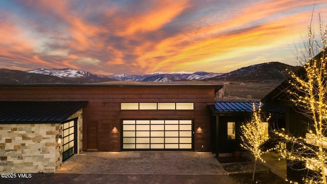 1658 E Haystacker Dr, Eagle, CO 81631 - view of front of house with a standing seam roof, a mountain view, metal roof, and a garage