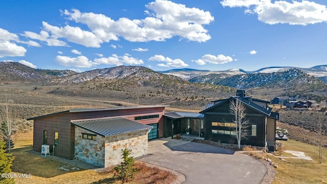 1658 E Haystacker Dr, Eagle, CO 81631 - view of front of home featuring a mountain view, curved driveway, and stone siding