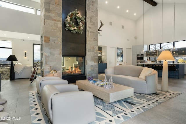 1658 E Haystacker Dr, Eagle, CO 81631 - living area with high vaulted ceiling, beam ceiling, a stone fireplace, and recessed lighting
