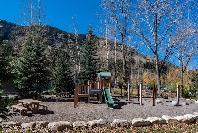 view of playground featuring a mountain view