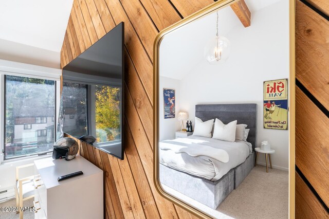 bedroom featuring vaulted ceiling with beams and carpet floors