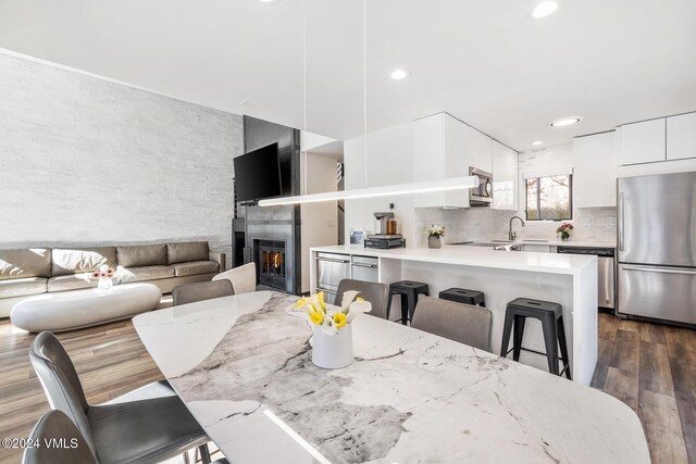 dining space with dark hardwood / wood-style flooring and sink