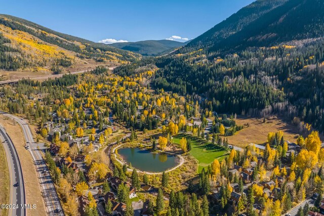 drone / aerial view with a water and mountain view