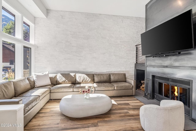 living room with wood-type flooring and a towering ceiling