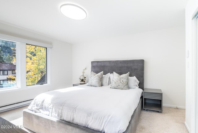 carpeted bedroom with a baseboard radiator