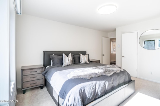 carpeted bedroom with a baseboard heating unit