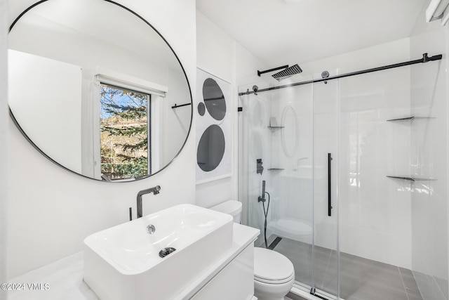 bathroom with vanity, an enclosed shower, and toilet