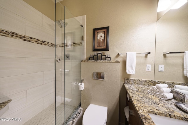 531 E Lionshead Cir Unit 303, Vail, CO 81657 - full bathroom with vanity, a stall shower, toilet, and a textured wall