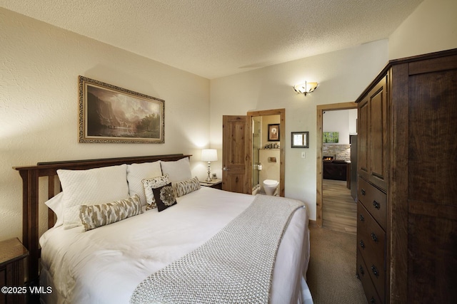 531 E Lionshead Cir Unit 303, Vail, CO 81657 - bedroom featuring carpet flooring, connected bathroom, and a textured ceiling
