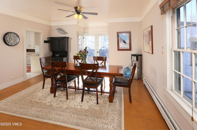 546 Grand Ave, Eagle, CO 81631 - dining space with baseboard heating, ceiling fan, baseboards, and light wood finished floors