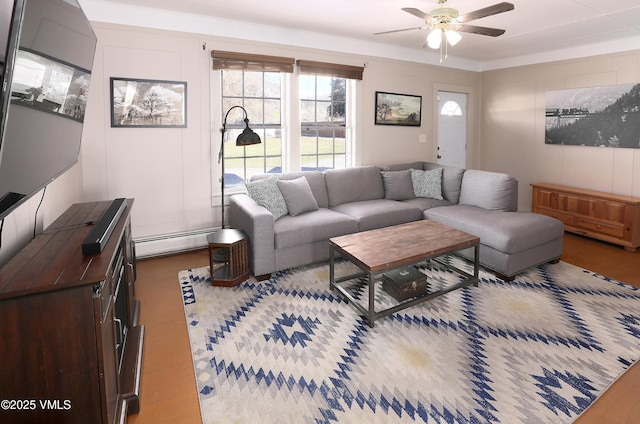 546 Grand Ave, Eagle, CO 81631 - living area featuring a decorative wall, a baseboard radiator, wood finished floors, and ceiling fan
