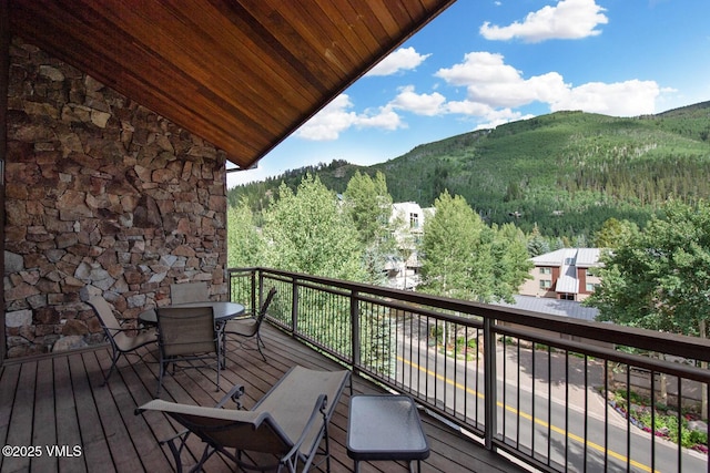 1325 Westhaven Dr Unit A302, Vail, CO 81657 - wooden terrace featuring a mountain view, outdoor dining area, and a forest view