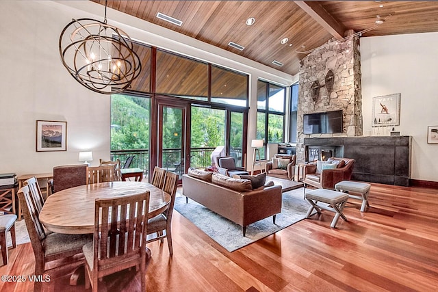 1325 Westhaven Dr Unit A302, Vail, CO 81657 - living area featuring a wood ceiling with exposed beams, wood finished floors, a chandelier, a fireplace, and high vaulted ceiling