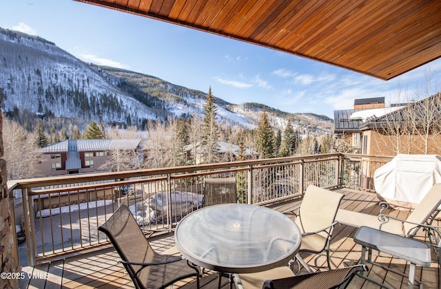 1325 Westhaven Dr Unit A302, Vail, CO 81657 - snow covered back of property featuring outdoor dining area, area for grilling, and a deck with mountain view