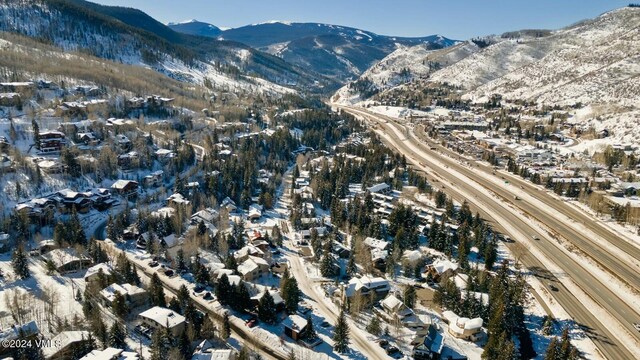 snowy aerial view featuring a mountain view