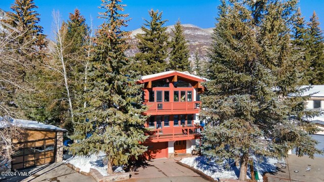 back of house with a balcony and a mountain view