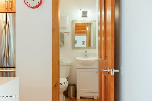 bathroom featuring vanity and toilet