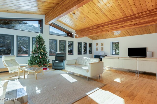 unfurnished sunroom with wood ceiling, plenty of natural light, and vaulted ceiling with beams