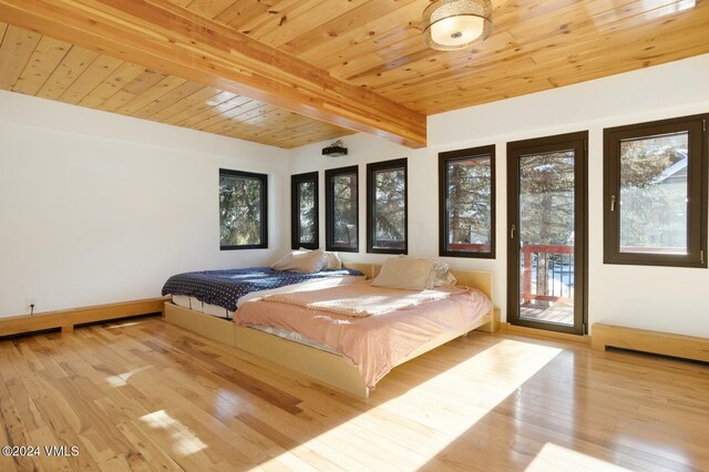 unfurnished bedroom with wooden ceiling, light wood-type flooring, beamed ceiling, access to exterior, and multiple windows