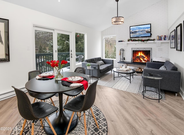 4480 Timber Falls Ct Unit 1507, Vail, CO 81657 - dining room featuring lofted ceiling, wood finished floors, and a fireplace
